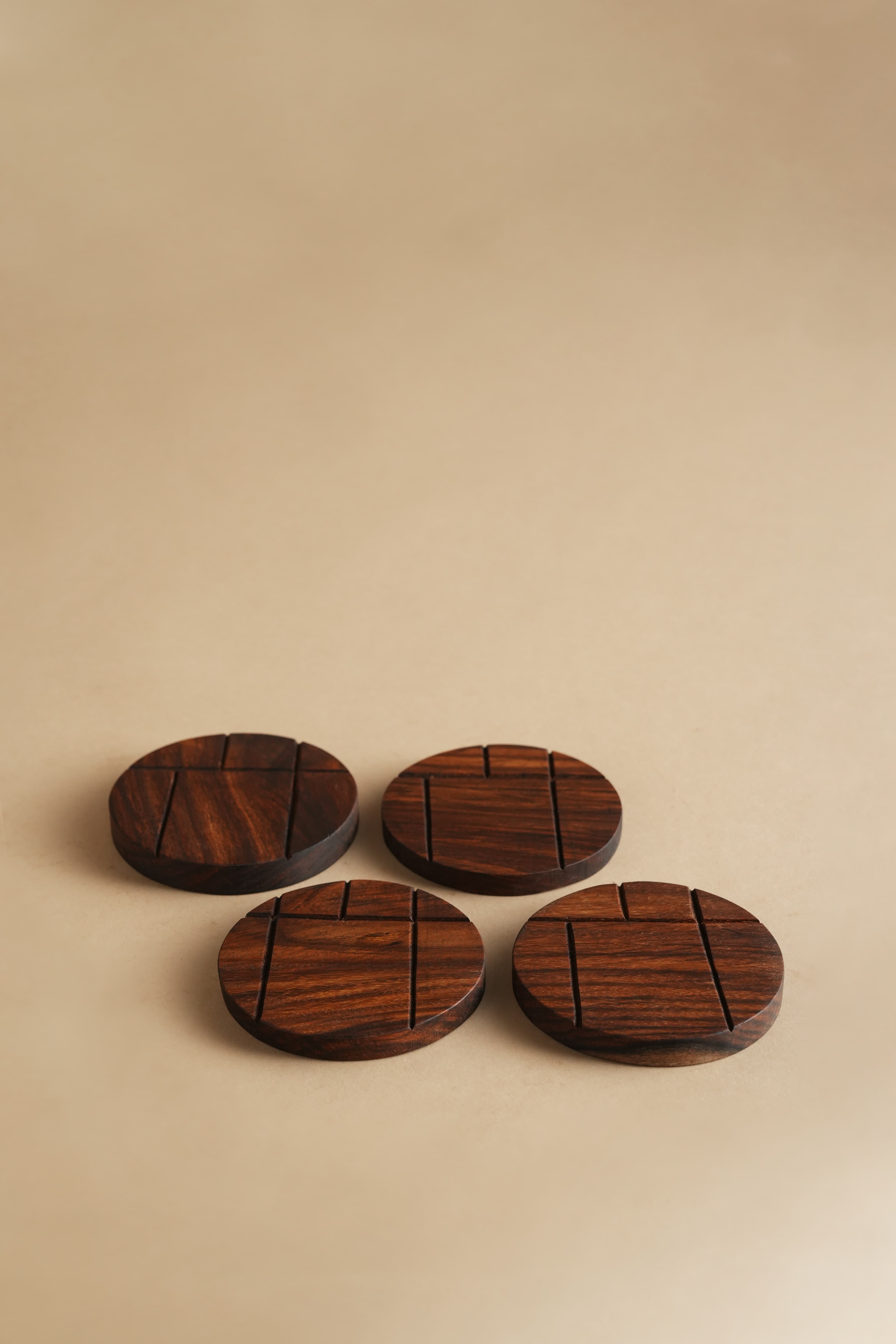 Hand-Carved Round Sheesham Table Coasters (Set of 4) - Studio View